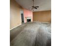 Spacious living room with a fireplace and neutral color scheme, awaiting personal touches at 4401 Chestnut Lake Ave, Lithonia, GA 30038