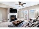 Bright living room with a fireplace, ceiling fan, and access to a balcony, providing natural light at 7620 Stoneridge Dr, Atlanta, GA 30328