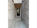 Charming entrance featuring a brick-lined walkway leading to a glass-paneled front door at 950 Sunny Lake Dr, Lawrenceville, GA 30043