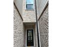 Charming entrance featuring a brick-lined walkway leading to a glass-paneled front door at 950 Sunny Lake Dr, Lawrenceville, GA 30043