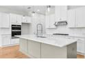 Bright kitchen with stainless steel appliances, white cabinets and a large gray kitchen island at 2540 Silver Star Ne Dr, Marietta, GA 30066