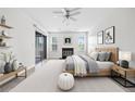 Tranquil main bedroom includes a fireplace, a ceiling fan, and sliding glass doors to outdoor balcony at 66 Fair Haven Se Way, Smyrna, GA 30080