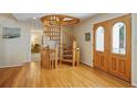 Foyer with a stunning spiral staircase and elegant wood flooring at 80 Seville Chase, Atlanta, GA 30328