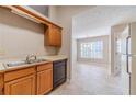 Traditional kitchen with oak cabinets, laminate countertops, neutral tiling, and ample sunlight at 3005 Summit View Ct, Snellville, GA 30078