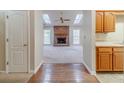 Inviting living room featuring a cozy brick fireplace, wood floors, and natural light from skylights at 3005 Summit View Ct, Snellville, GA 30078