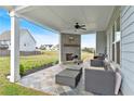 Enjoy this outdoor covered patio featuring a stone fireplace and comfortable seating, perfect for relaxing at 95 Summerlyn Dr, Hiram, GA 30141