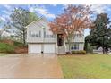 Charming split-level home featuring a two-car garage and landscaped yard at 104 Puckett Creek Dr, Canton, GA 30114
