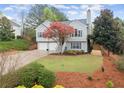 Charming split-level home featuring a two-car garage and beautifully landscaped front yard at 104 Puckett Creek Dr, Canton, GA 30114