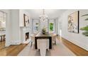 Bright dining room featuring a chandelier, fireplace, and large windows with draperies at 235 The Prado N, Atlanta, GA 30309