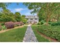 Beautifully landscaped front yard leading to a classic two-story home with dormer windows at 235 The Prado N, Atlanta, GA 30309