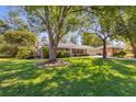Beautifully landscaped front yard with mature trees surrounding an attractive single-story home with shutters at 3113 Octavia Pl, Atlanta, GA 30340