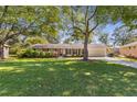 Attractive single-story home boasts a lush green lawn and mature shade trees in a desirable neighborhood at 3113 Octavia Pl, Atlanta, GA 30340
