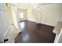 Bright living room with dark hardwood floors and a unique spiral staircase at 1075 Peachtree Ne Walk # A519, Atlanta, GA 30309