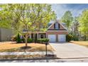 Charming two-story home with a well-manicured lawn, mature trees, and a two car garage at 3285 Pebble Ridge Ln, Buford, GA 30519