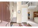 Bright foyer with wood floors, stairs and second level balcony creating an open and inviting entryway at 465 Hunt River Way, Suwanee, GA 30024