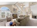 Inviting living room with cathedral ceilings, arched windows, and cozy fireplace at 465 Hunt River Way, Suwanee, GA 30024