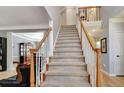 Carpeted staircase with wood railing leading to the second floor at 155 Woodcreek Ln, Fayetteville, GA 30215