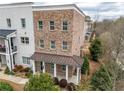 Lovely exterior view of the brick townhouse and inviting covered front porch at 2026 Forte Ln, Alpharetta, GA 30009