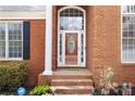Elegant front door with decorative glass, flanked by sidelights and black shutters, inviting and secure at 2503 Westchester Se Way, Conyers, GA 30013