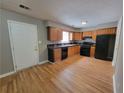 Well-lit kitchen featuring a full suite of appliances, wooden cabinets, and ample counter space at 3512 Ten Oaks Ct, Powder Springs, GA 30127