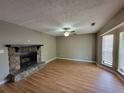 Spacious living room with stone fireplace, ceiling fan, and lots of natural light at 3512 Ten Oaks Ct, Powder Springs, GA 30127