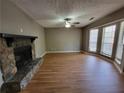 Open living room featuring a fireplace, wood floors, and many windows at 3512 Ten Oaks Ct, Powder Springs, GA 30127