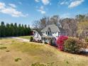 Beautiful home featuring lush landscaping, a barn, and a serene, expansive front yard at 1130 Martins Chapel Rd, Lawrenceville, GA 30045