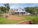 Charming home with inviting front porch, red brick, blue shutters, and lush landscaping at 3174 Country Club Nw Ct, Kennesaw, GA 30144