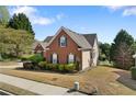 Charming red-brick home with manicured landscaping and lush green lawn at 3503 Dunbar Ln, Suwanee, GA 30024