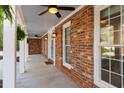 Inviting front porch featuring brick facade, elegant windows and outdoor lighting at 3824 Running Fox Dr, Marietta, GA 30062