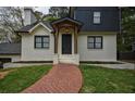 Close-up of the front of the home with brick facade and a brick walkway leading to the front porch at 2048 Kelvin Dr, Lawrenceville, GA 30043