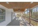 Spacious front porch with a stained wood ceiling, providing ample room for relaxing at 2095 Highway 20 Ne, Conyers, GA 30012