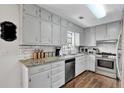 Kitchen boasts granite countertops, stainless steel appliances, and white subway tile backsplash at 2806 Peachtree Walk, Duluth, GA 30096