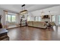 Cozy living room with hardwood floors, large windows, stone fireplace, and modern lighting at 2806 Peachtree Walk, Duluth, GA 30096