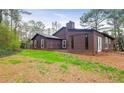 The home features a backyard with a patio, perfect for outdoor entertaining and relaxation with its serene setting at 3955 Chimney Ridge Ct, Ellenwood, GA 30294