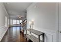 Bright entryway featuring hardwood floors, staircase, and decorative console table with stylish lamp at 4569 Grenadine Cir, Acworth, GA 30101
