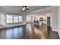Open-concept living room featuring hardwood floors, large windows, and seamless flow to the kitchen at 4569 Grenadine Cir, Acworth, GA 30101