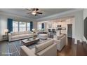 Bright, staged living room with hardwood floors flowing into the open kitchen concept at 4569 Grenadine Cir, Acworth, GA 30101