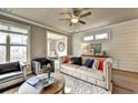 Comfortable living room with modern ceiling fan, hardwood floors, stylish furniture, and lots of sunlight at 2822 Evanshire Ave # 111, Duluth, GA 30096
