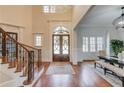 Bright foyer with high ceilings, detailed millwork, and a view of the double front doors and formal dining room at 5394 Brendlynn Dr, Suwanee, GA 30024