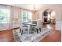 Inviting dining space featuring a decorative chandelier and adjacent living room with a fireplace at 1107 Fieldstone Dr, Canton, GA 30114