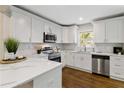 Bright kitchen with white cabinets, quartz countertops, stainless steel appliances, and hardwood floors at 2297 Sheryl Dr, Decatur, GA 30032