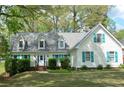 Well-maintained home with green lawn, dormer windows, and blue shutters at 5215 Silver Creek Dr, Lilburn, GA 30047
