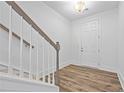Home entryway featuring wood-style flooring, white walls and trim, leading to the upper level at 1520 Parks Edge Nw Ln, Atlanta, GA 30318