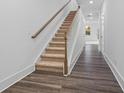 Bright hallway with wooden floors and a carpeted staircase leading to the upper level at 1520 Parks Edge Nw Ln, Atlanta, GA 30318