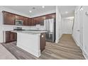 Modern kitchen features dark wood cabinets, stainless appliances, granite countertops, and center island at 1520 Parks Edge Nw Ln, Atlanta, GA 30318