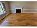 Spacious living room featuring a fireplace, hardwood floors, and large windows at 5922 Graywood Cir, Mableton, GA 30126