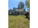 Charming one-story home with a well-maintained lawn, landscaping, and a cozy front entrance at 2220 Wellington Cir, Lithonia, GA 30058