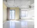 Bright, open living area with polished concrete floors and modern industrial accents at 335 W Ponce De Leon Ave # 506, Decatur, GA 30030