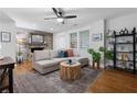 Bright living room featuring hardwood floors, a ceiling fan, and a cozy sectional sofa at 1963 Main Nw St, Atlanta, GA 30318